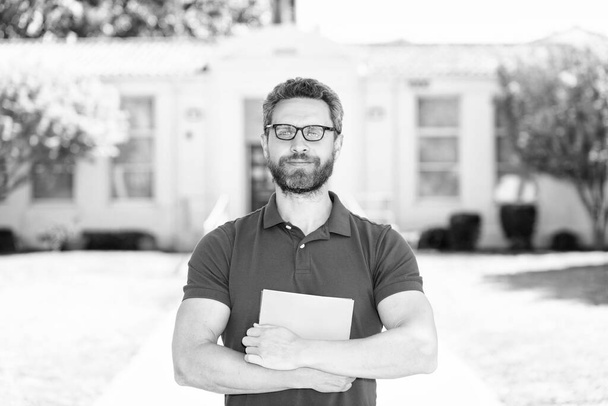 dreamy positive man in glasses with paper sheet, education. - Photo, Image