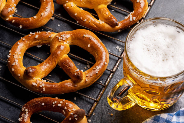 Freshly baked homemade pretzels and draft beer - Photo, Image