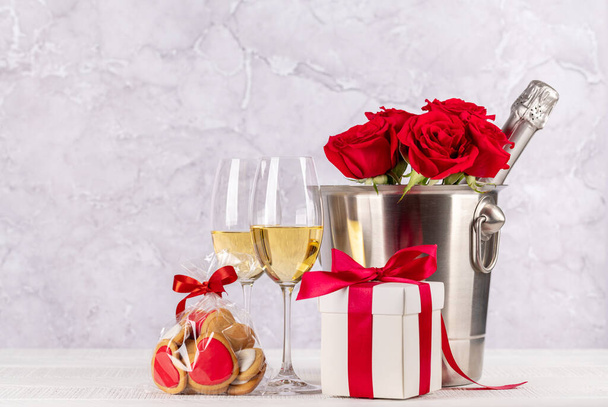 Valentines day card with champagne, rose flowers and gift box. With space for your greetings - Photo, Image