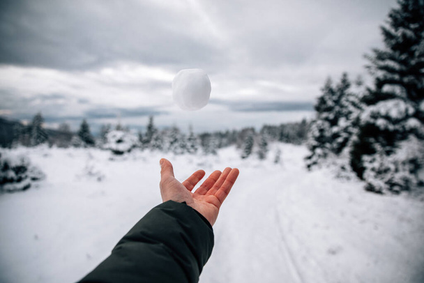 man hand dropping a snowball - Photo, Image