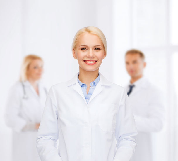 smiling female doctor with group of medics - Valokuva, kuva