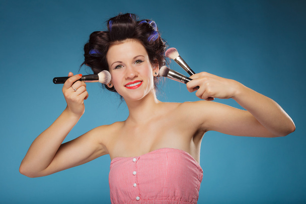 Woman holding makeup brushes - Fotó, kép