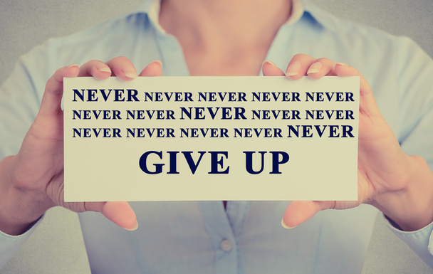 businesswoman hands holding card with never give up sign message  - 写真・画像