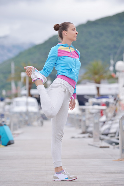 Woman stretching in marina - Photo, Image