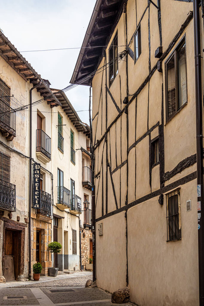 The old town of the medieval village of Covarrubias, Burgos, Castilla y Leon, Spain. Traditional streets with traditional patterns on the buildings walls in the medieval town - 写真・画像