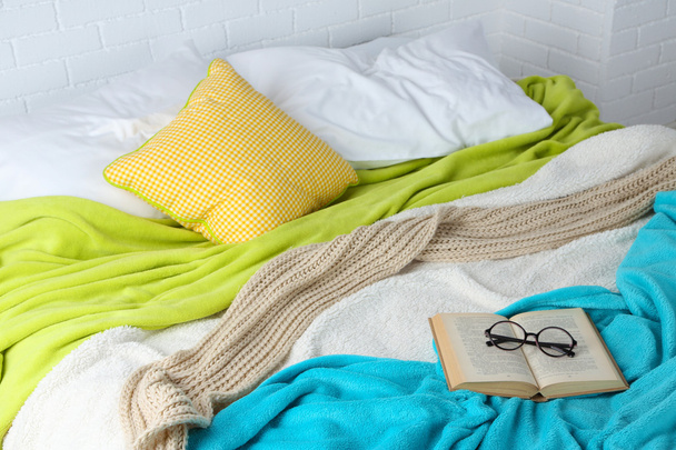 Book and glasses on bed - Zdjęcie, obraz