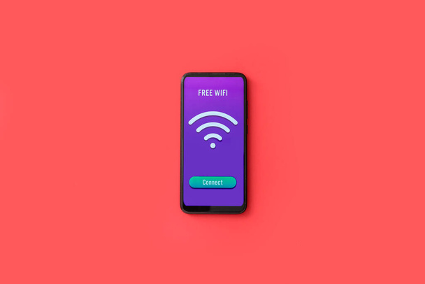 Handy mit WiFi-Symbol und Verbindungstaste auf farbigem Hintergrund - Foto, Bild