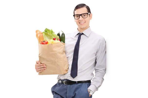 Man holding a grocery bag - Fotoğraf, Görsel