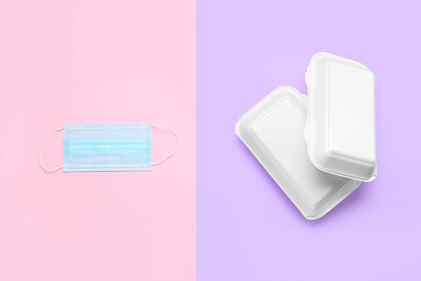 Takeaway boxes and medical mask on color background - Photo, Image