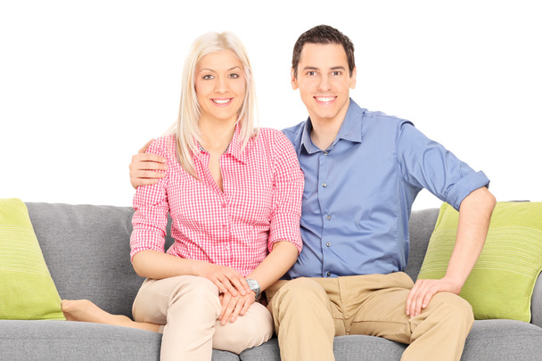 Young couple sitting on sofa - Фото, зображення