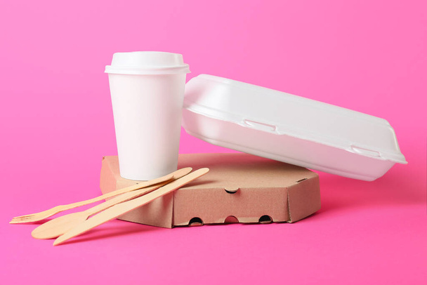 Food boxes, paper cup and wooden cutlery on color background - Photo, Image