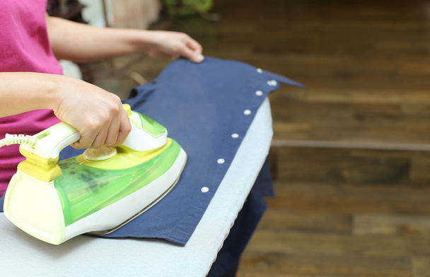 Woman ironing a blue shirt - Photo, Image