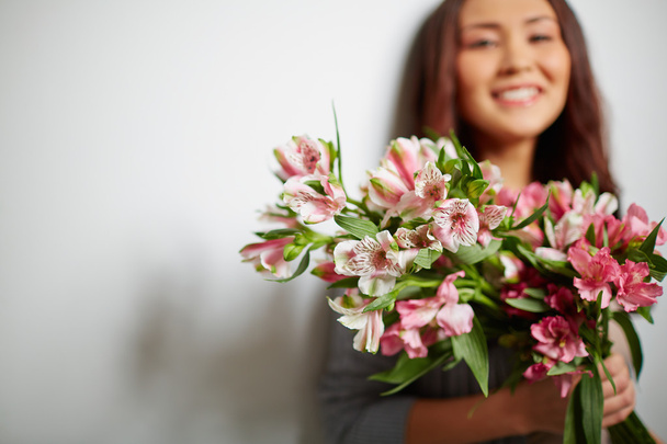 Girl holding amaryllis  flowers - 写真・画像