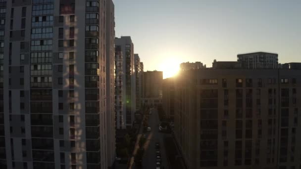 Flying along house windows and facades towards the sunset sky. Stock footage. Architecture of a modern sleeping area  - Footage, Video