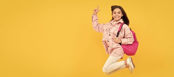happy child girl wear pink checkered shirt jumping school backpack, full of energy. Banner of school girl student. Schoolgirl pupil portrait with copy space - Photo, image