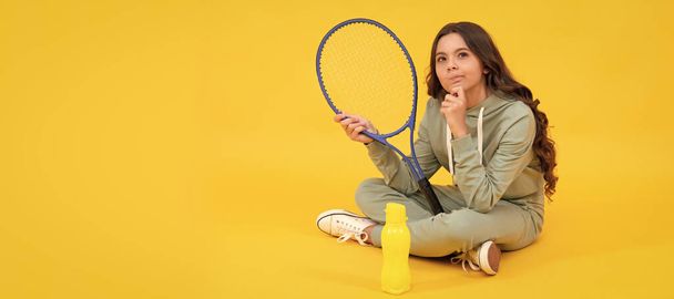 thinking child with tennis racquet. teen girl after sport training. dedicated to fitness. Horizontal poster of isolated child face, banner header, copy space - Photo, Image