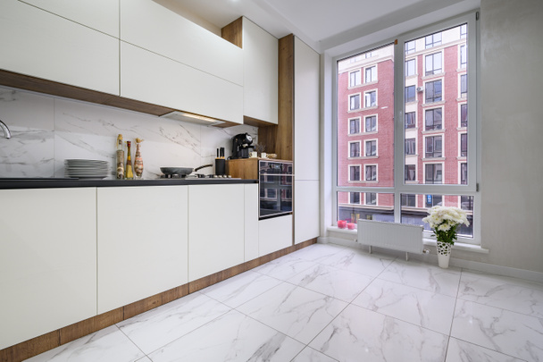 Черно-белый современный роскошный интерьер кухни с большим окном - Фото, изображение