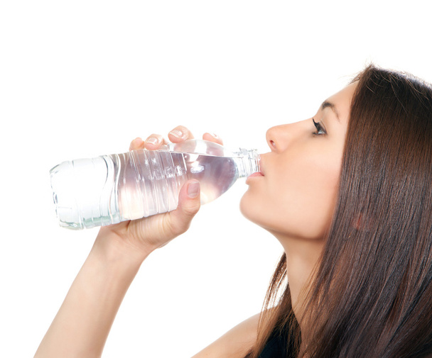 Woman drinking water from plastic bottle - Фото, изображение