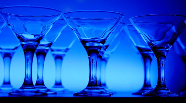 Wineglasses on the table in blue light - Valokuva, kuva