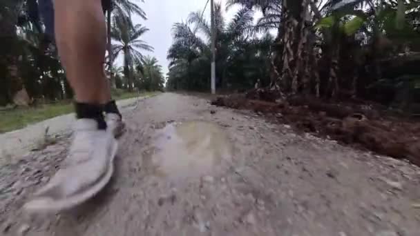someone walking alone on the wet sandy rural countryside road  - Footage, Video