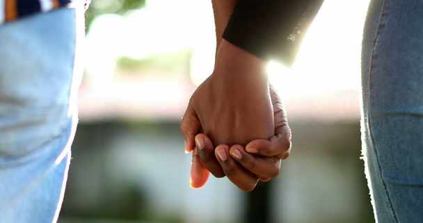 Black couple holding hands outside during golden hour time sunset - Photo, Image