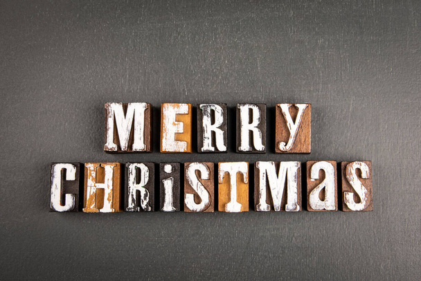 Boldog karácsonyt! Szöveg fa ábécé blokkok sötét táblán háttér. - Fotó, kép
