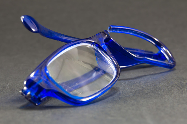 blue broken glasses on black background - Photo, Image