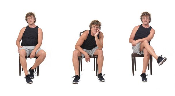  front view of same man with sportswear sitting on chair on white background - Photo, Image