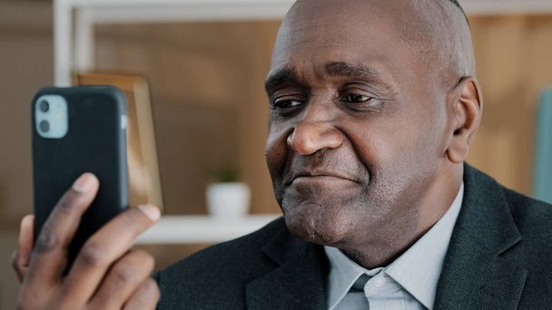 Closeup male portrait African American 50s old middle-aged businessman emotional professional man online remote conversation manager worker looking in mobile phone camera talking conference video call - Zdjęcie, obraz