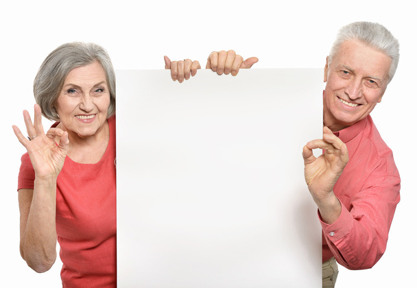 Old age couple holding blank - Foto, afbeelding