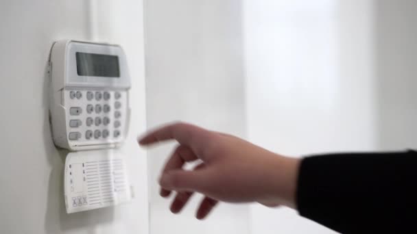 Hand entering alarm system password of an apartment, home or business office. Surveillance and protection console against rubbery and thief  - Footage, Video