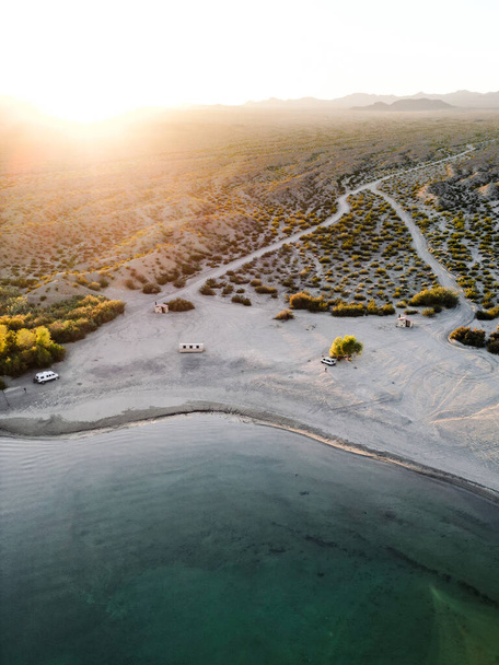 aerial view drone shot of lake mohave in the national recreation area of lake mead in nevada and arizona with the sun setting showing six mile cove and its sand - Photo, Image