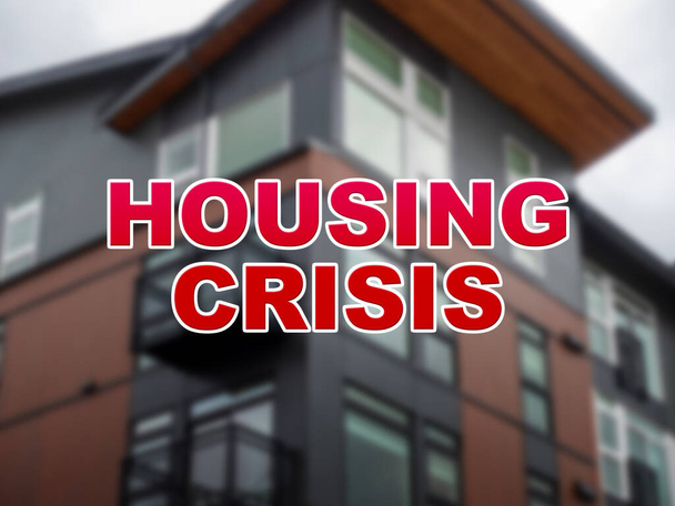 Wazige achtergrond van een woongebouw met de woorden Housing Crisis op de voorgrond - Foto, afbeelding