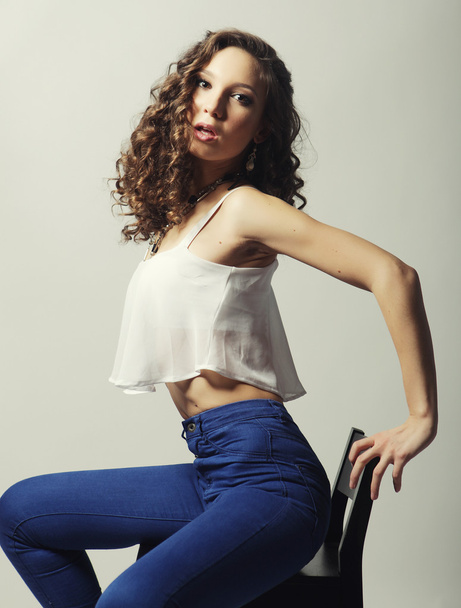 Young fashion model sitting on chair - Foto, immagini