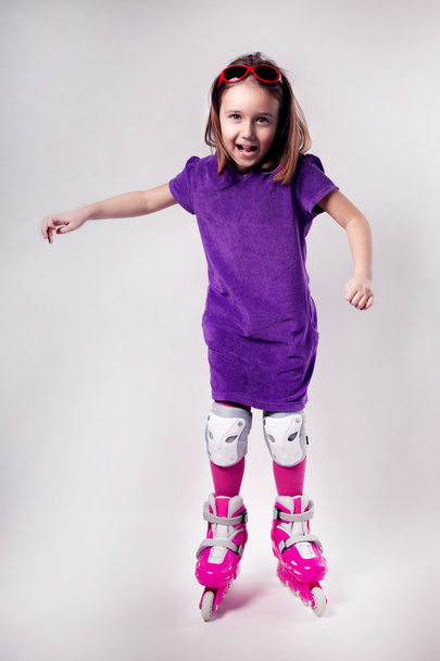 Portrait of emotional sports  kid with roller skate - Fotó, kép