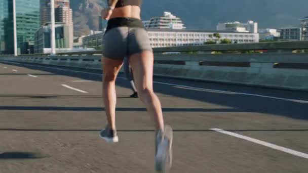 Fitness, city and women on road running for marathon training, cardio exercise and workout challenge. Sports, competition and legs of girls run in urban town for healthy lifestyle, endurance and race. - Footage, Video
