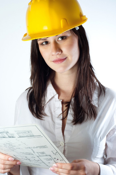 Beautiful business woman with construction plans - Фото, зображення