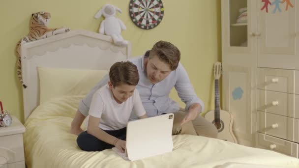 The father is angry with his little son for spending too much time on the internet and in games, he tries to take his computer away from him. Technology and social media addiction in children. - Footage, Video