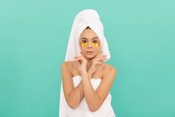 teen girl in shower towel with golden patch. cosmetology. - Photo, Image