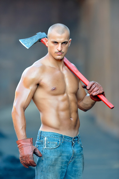 athletic young man holding ax - 写真・画像
