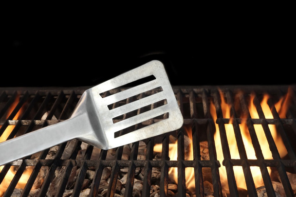Spatula on the Flaming BBQ Grill - Photo, Image