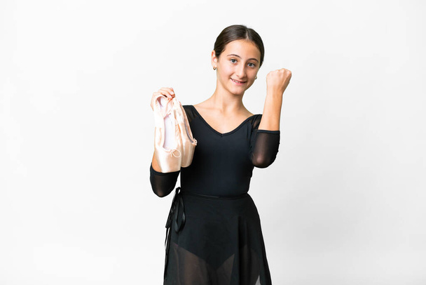 Young woman practicing ballet over isolated white background celebrating a victory - Foto, imagen