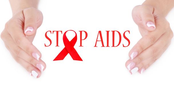 Woman with aids awareness red ribbon in hands - Foto, imagen