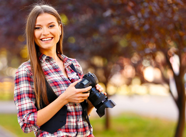 Young photographer taking photos outdoors - Photo, Image