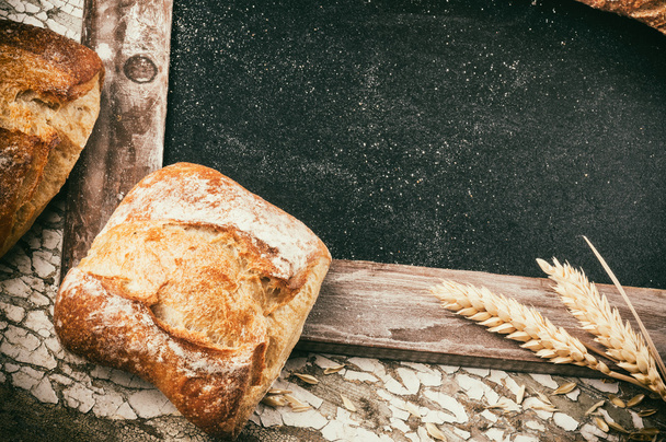 Rustic frame with bread and wheat - Фото, зображення