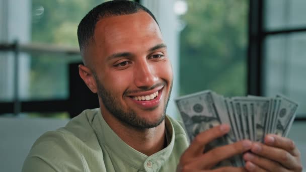 Male portrait happy smiling rich success Latin man counting money African American businessman holding fan of dollars banknotes cash financial winning prize enjoy exchange savings salary finance bribe - Footage, Video