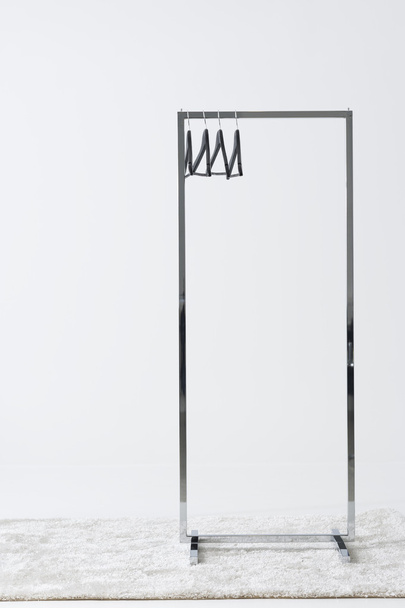 Metal clothing rail with empty coat hangers - Foto, imagen