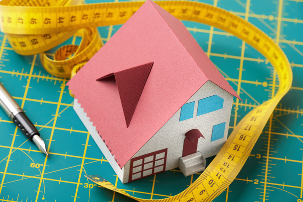 Toy house on graph background - Photo, Image