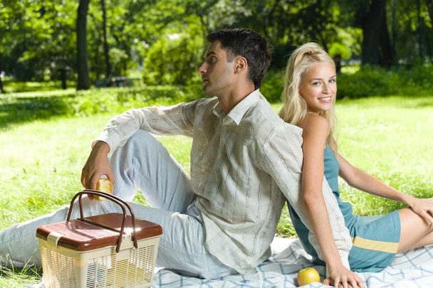 Young happy amorous couple together at picnic, outdoors - 写真・画像