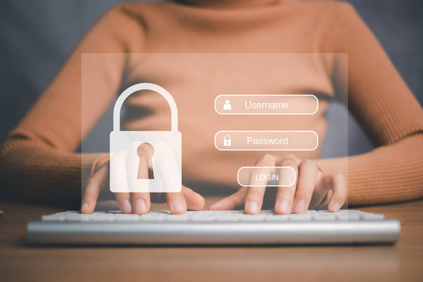 女性の手は、画面表示上のログインとパスワードでキーボードを入力し、サイバーセキュリティの概念、データ保護と安全なインターネットアクセスを確保. - 写真・画像